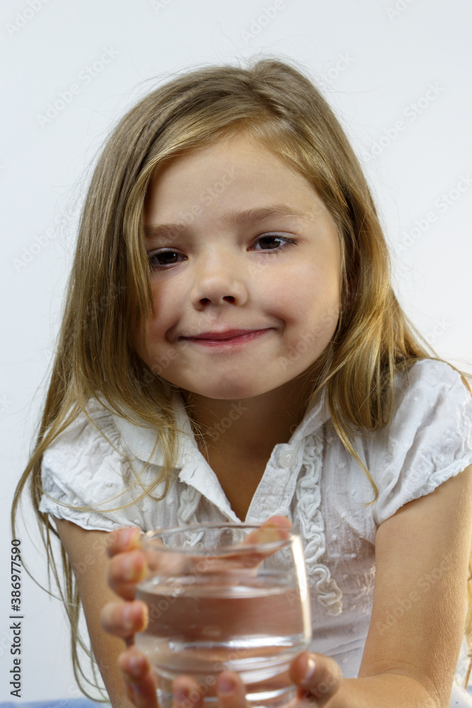 Portrait of a girl in a white shirt with a glass of water. Portrait of a girl in a white shirt with a glass of water.