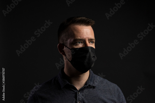 Man Wearing Face Mask Looking Off to Side