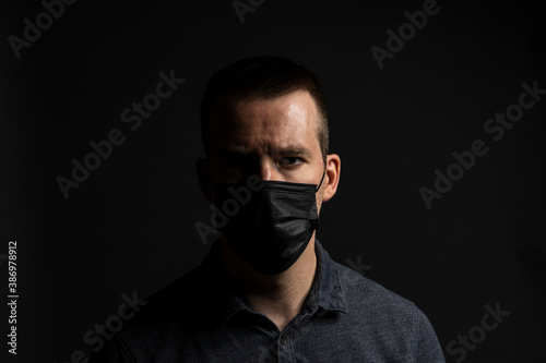Man Wearing Face Mask on Dark Background © Daniel Gill