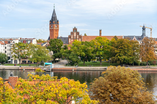 Berlin Germany District Köpenick old town city hall clock tower on river with fall autumn season colorful leaves changing on trees