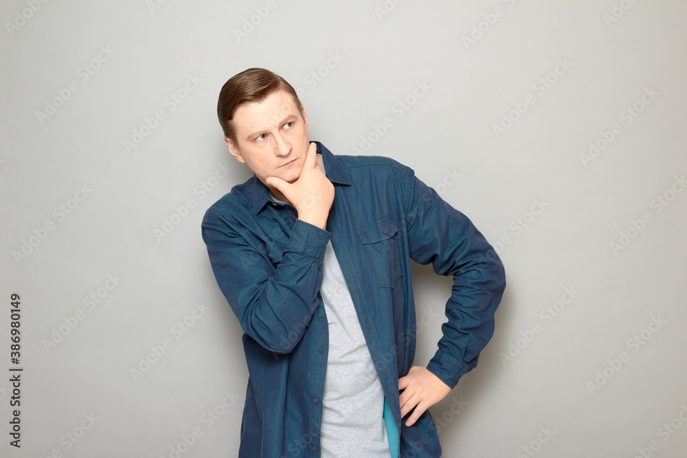 Portrait of thoughtful man touching chin with hand and thinking hard Portrait of thoughtful man touching chin with hand and thinking hard