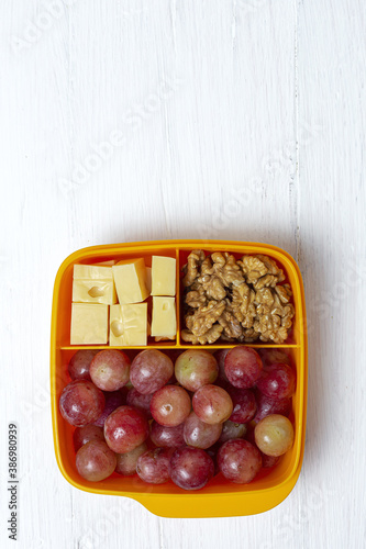 Food in Plastic containers ready to eat with Cheese, grapes and nuts