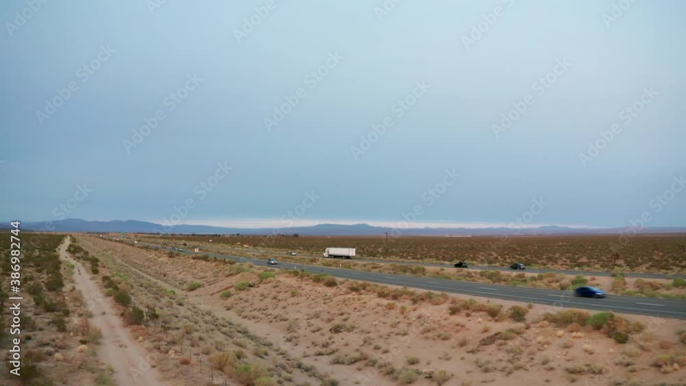 Truck transporting a heavy payload through the Mojave Desert - aerial view Truck transporting a heavy payload through the Mojave Desert - aerial view