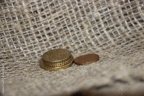 Some Euro coins on burlap canvas background. Little money concept. Powerty concept photo