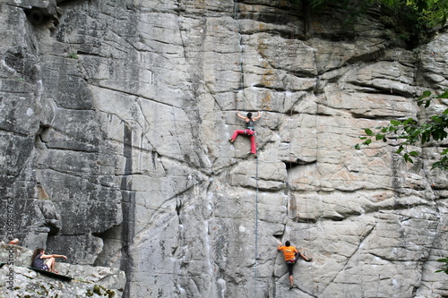 people climb the cliff in nature with insurance
