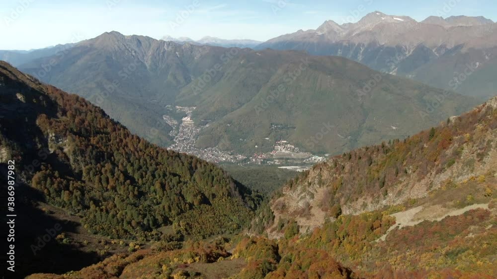 Aerial view flight in autumn over beautiful forest in the mountains. Colorful panorama of the mountains at sunset. Travel and recreation in the mountains Aerial view flight in autumn over beautiful forest in the mountains. Colorful panorama of the mountains at sunset. Travel and recreation in the mountains