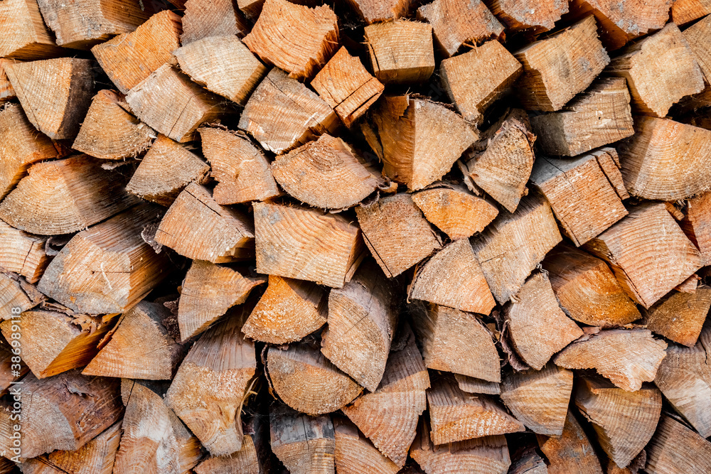 wall firewood , Background of dry chopped firewood logs in a pile. Firewood texture. Stack of dry chopped wooden logs. natural wooden background with timber. log wall. wall firewood , Background of dry chopped firewood logs in a pile. Firewood texture. Stack of dry chopped wooden logs. natural wooden background with timber. log wall.