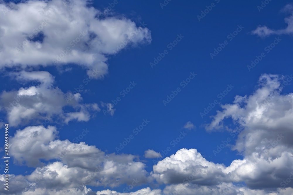 white cumulus clouds against a bright blue sky white cumulus clouds against a bright blue sky