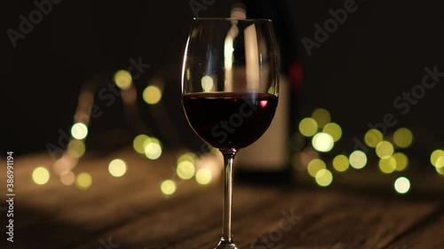 glass of red wine on a wooden restaurant table slow movement