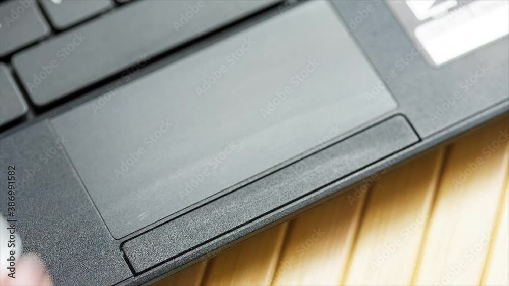 Cleaning, disinfecting, sanitizing a laptop touchpad with wet tissue