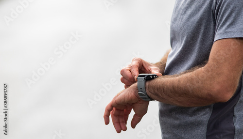 runner checking his smart watch