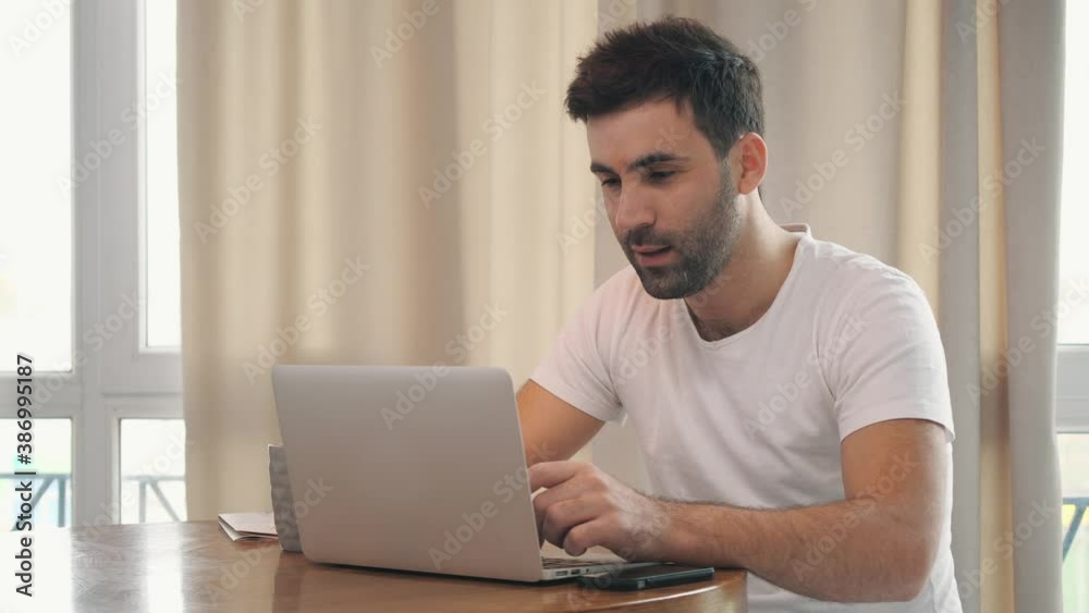 4k slowmotion video of positive man working remotedly. 4k slowmotion video of positive man working remotedly.