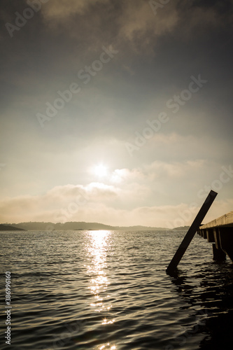 Vertical sea-level view of wooden ladder that descends into ocean in Kopstadso, a small island near Gothenburg Sweden photo