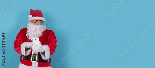santa claus isolated on background with mobile phone