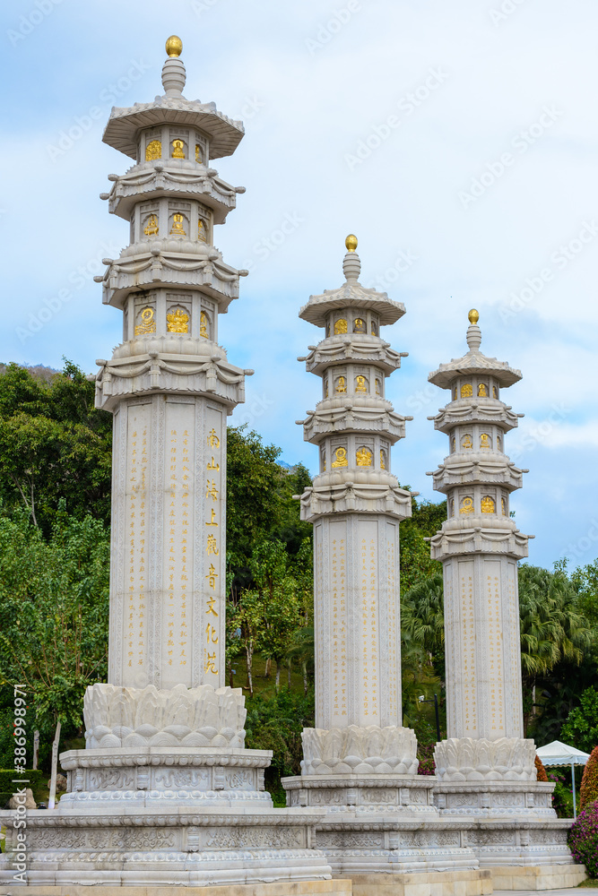 Buddhist stone pillars (prayer flags columns) on the territory of Buddhist center Nanshan on a cloudy day. Buddhist stone pillars (prayer flags columns) on the territory of Buddhist center Nanshan on a cloudy day.