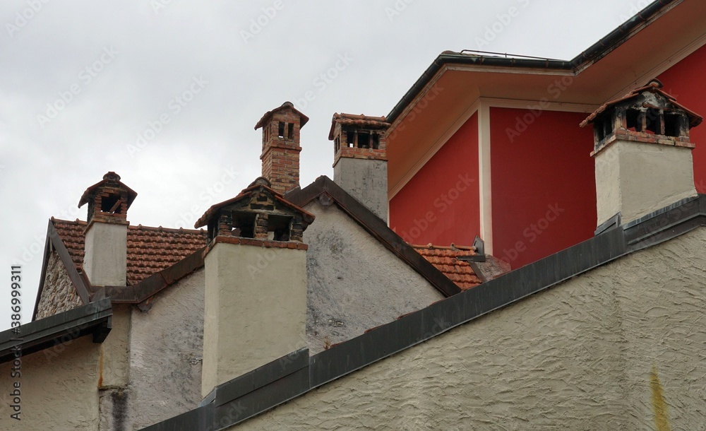 Rooftops and chimneys in the center of Lugano. The old houses in the city center are used for residential purposes. 