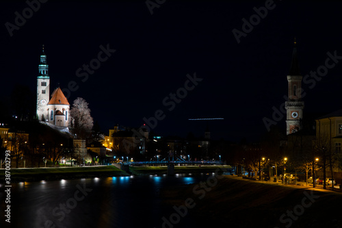 Salzburg old Europe city soft focus long exposure night landmark view with waterfront district with church tower in time before Christmas holiday © Артём Князь