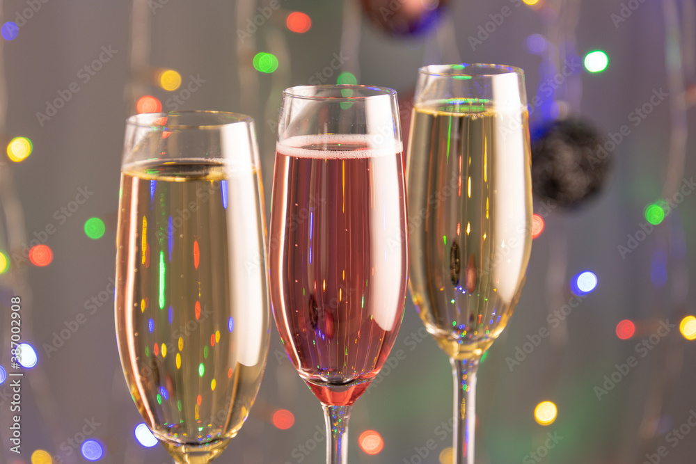 Three glasses of champagne with lights in the background. Three glasses of champagne with lights in the background.