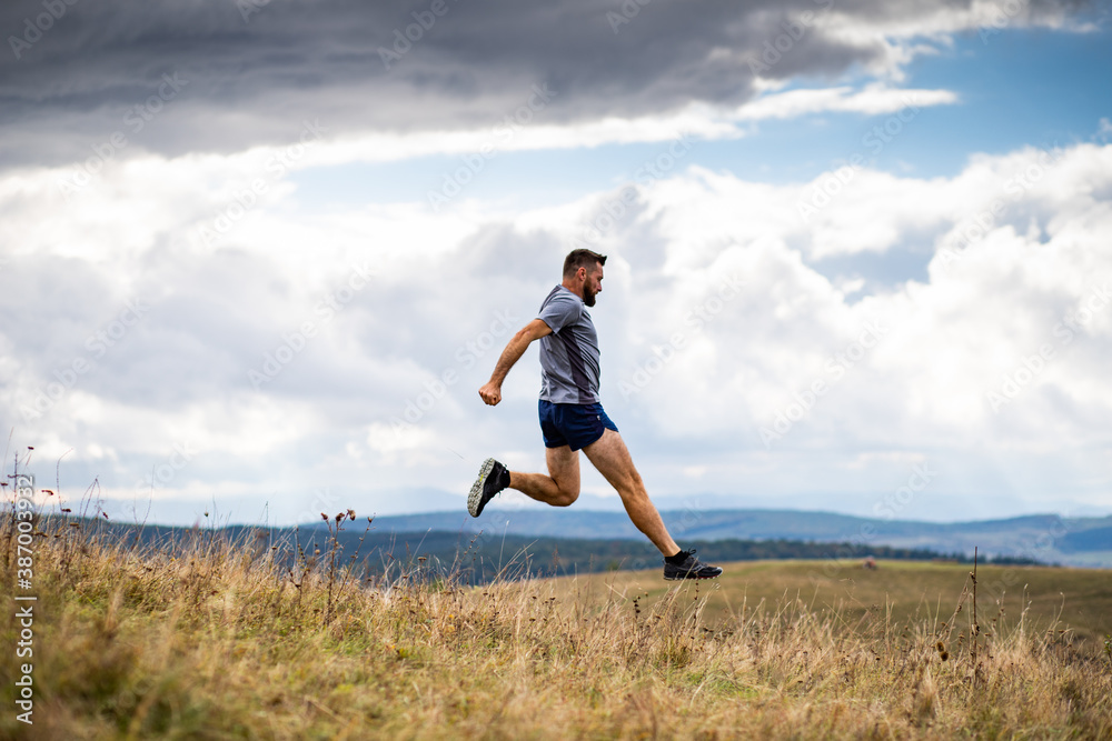 handsome trail runner running in nature