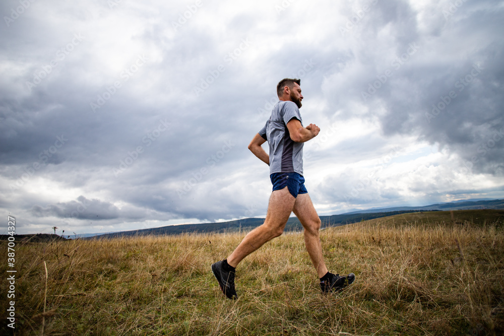 handsome trail runner running in nature handsome trail runner running in nature