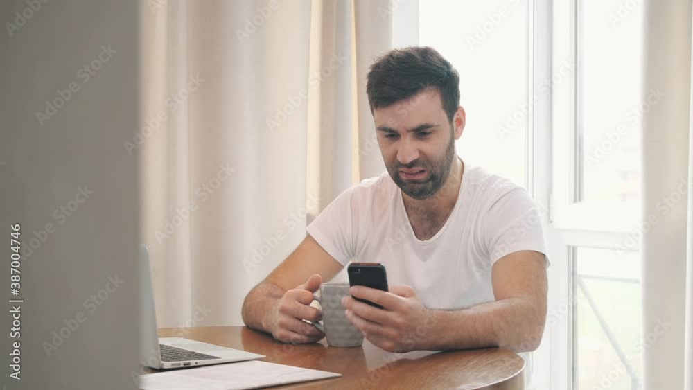 4k video of businessman using smartphone while drinking hot coffee. 4k video of businessman using smartphone while drinking hot coffee.