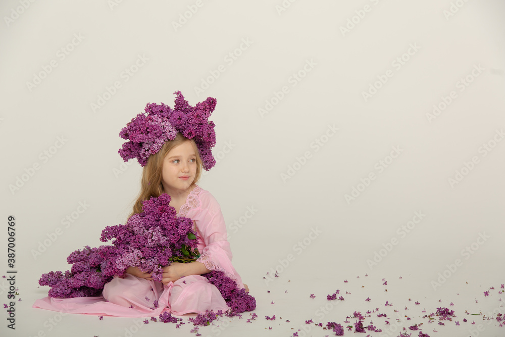 Little cute bright girl in the studio with lilac Little cute bright girl in the studio with lilac