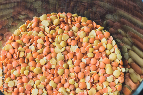 Glass pot  full of red and yellow lentils photo