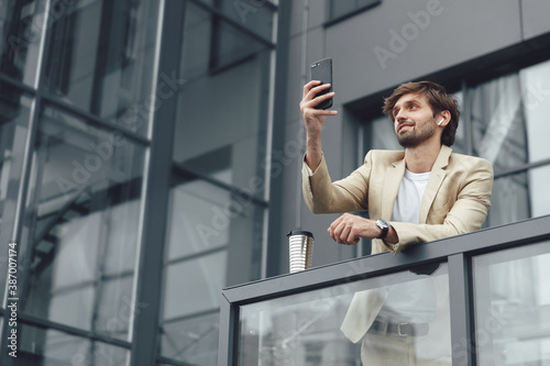 Wallpaper Mural Handsome man in formal wear having video chat on mobile Torontodigital.ca