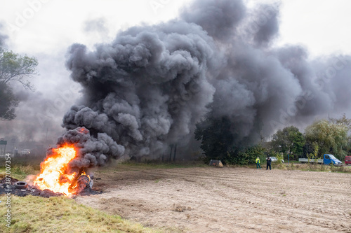 Black thick smoke above the burning tyres. Organistation 