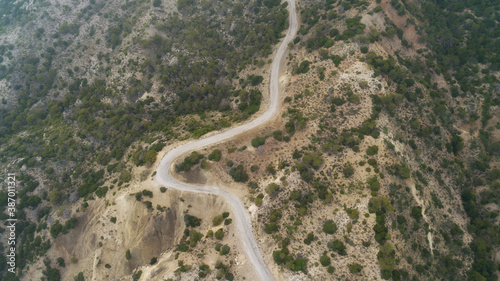 Winding road in mountain valley at sunset in summer. Aerial view of road in Greece. 