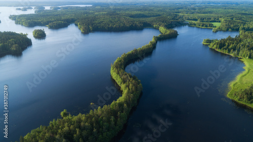  View from above of blue lake with islands and green forest in Finland. Beautiful summer landscape. Liesjarvi National Park. photo