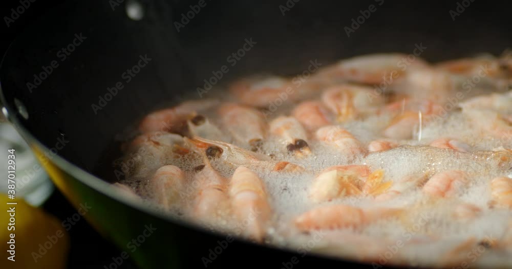 Cooking fragrant boiled shrimp. On a black background. Cooking fragrant boiled shrimp. On a black background.