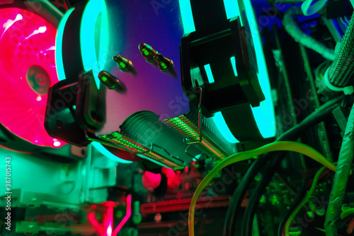 Modern computer air cooling with multi-colored led backlight-fans, cooling radiators, cables, boards, close-up, macro. © Wingedbull