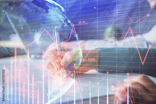 Double exposure of forex chart drawing over people taking notes background. Concept of financial analysis