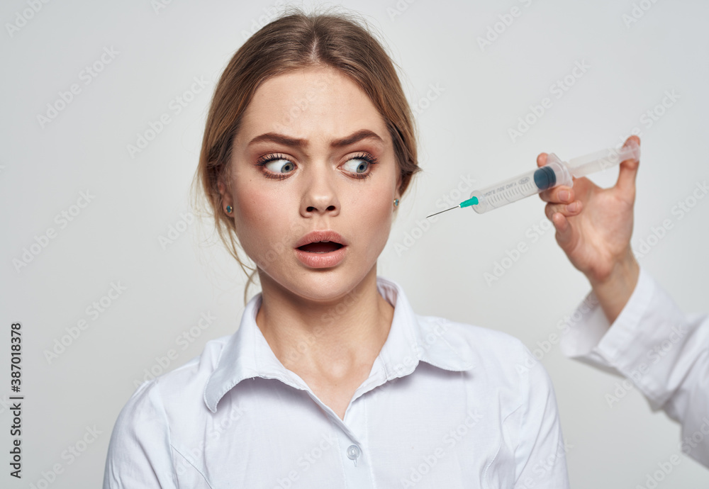scared woman and syringe with needle near face scared woman and syringe with needle near face