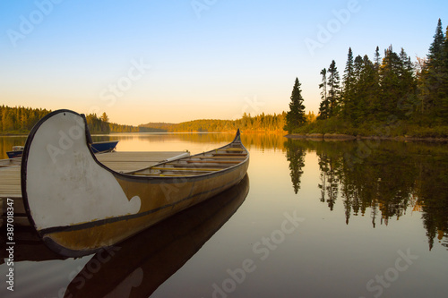 Canoe in a canadian lake of La Mauricie National Park at sunset (Mékinac, Quebec)