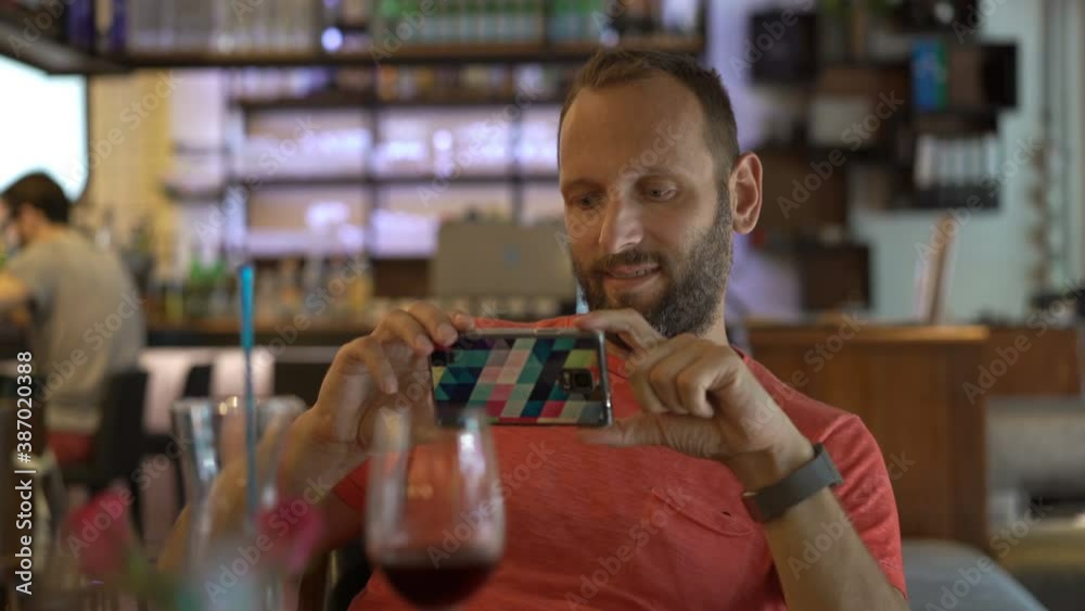 Young man taking smartphone selfie photo with wine in cafe Young man taking smartphone selfie photo with wine in cafe