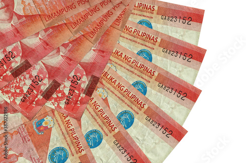 50 Philippine piso bills lies isolated on white background with copy space stacked in fan shape close up photo