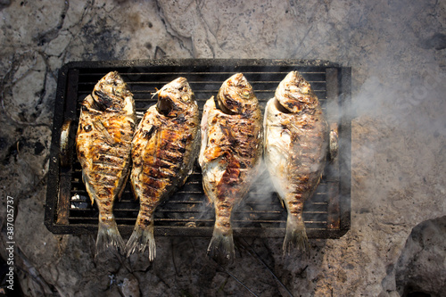 Fish grill with smoke on bbq