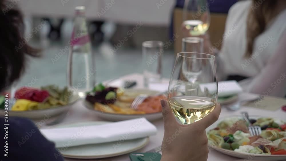 People with glass of champagne at the party. Woman hold wine drinking at welcome People with glass of champagne at the party. Woman hold wine drinking at welcome