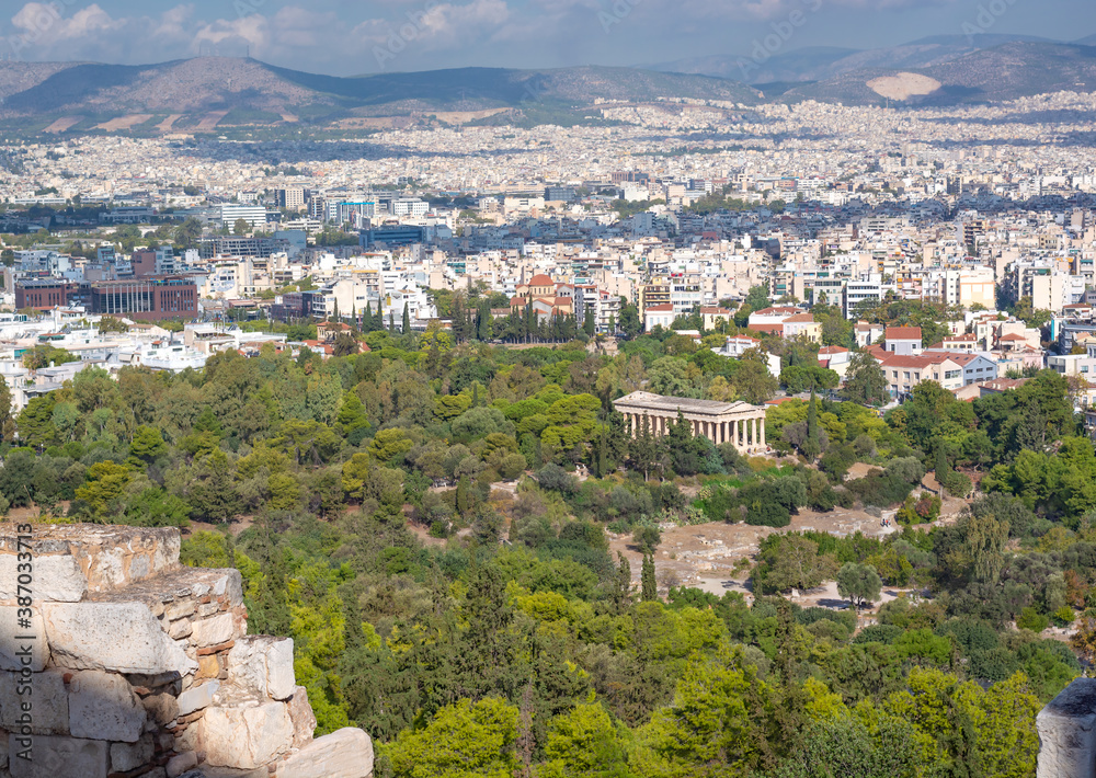 View of the Temple of Hephaestus among the greenery and the buildings of Athens in the distance