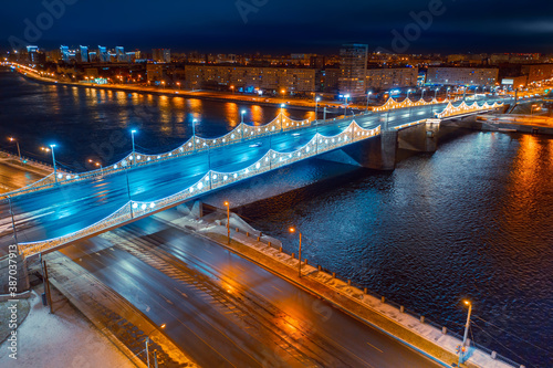 Night in a city. Panorama of Saint-Petersburg on a festive evening. Christmas in St. Petersburg. Russian city. Aerial view of the garlanded bridge. Bridges Of Petersburg.
