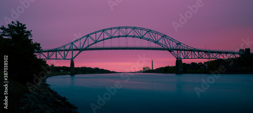 Sagamore Bridge and Cape Cod Canal Twilight Nightscape Silhouette Photo, Pink, and Turquoise Colored Cross-processed Panoramic Image. photo