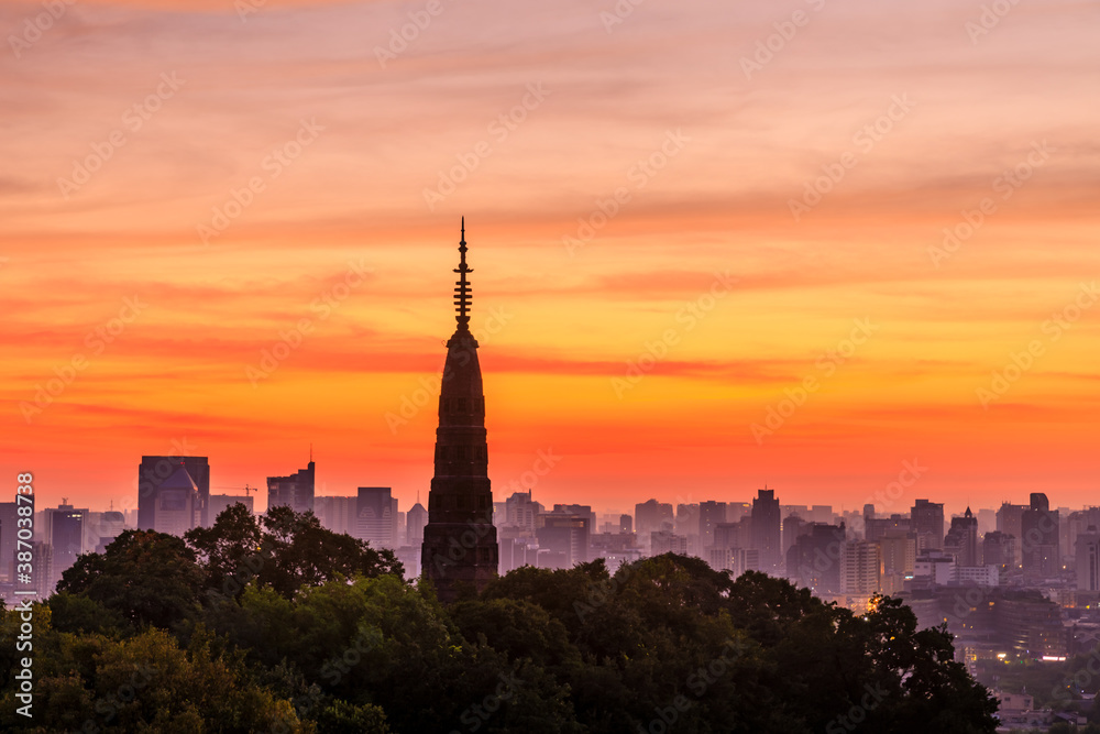 Naklejka premium Ancient Baochu Pagoda.Chinese traditional architecture and modern city skyline in Hangzhou at sunrise,China.