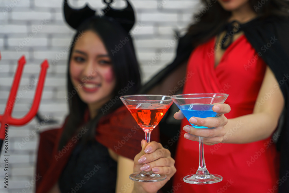 portrait of two asian women in witches costume portrait of two asian women in witches costume