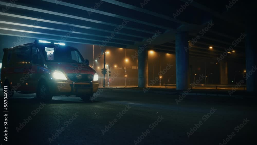 Ambulance Vehicle with Working Strobe Lights and Signal with Emergency Care Assistants Arrived on the Scene of a Traffic Accident on a Street at Night. Paramedics Team React to an Emergency Call.