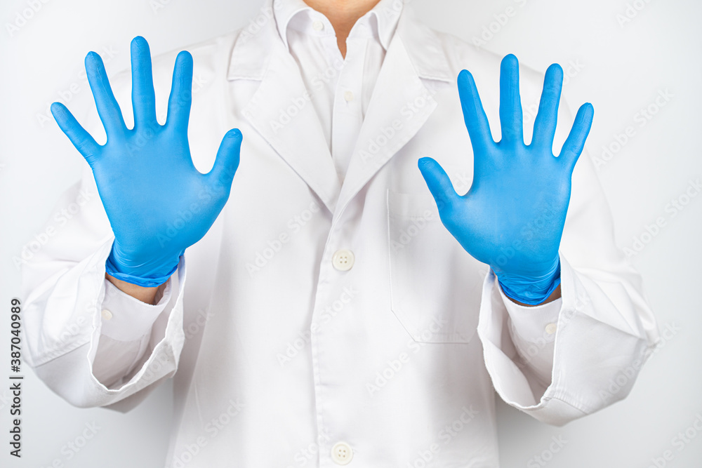 Fototapeta premium a doctor wearing blue latex gloves