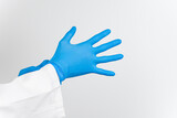 a doctor wearing blue latex gloves