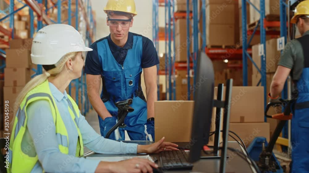 In Retail Warehouse Manager Uses Computer with Inventory Checking Software, Talks with Storehouse Worker about Package Delivery. International Distribution Center with Shelves Full of Products In Retail Warehouse Manager Uses Computer with Inventory Checking Software, Talks with Storehouse Worker about Package Delivery. International Distribution Center with Shelves Full of Products