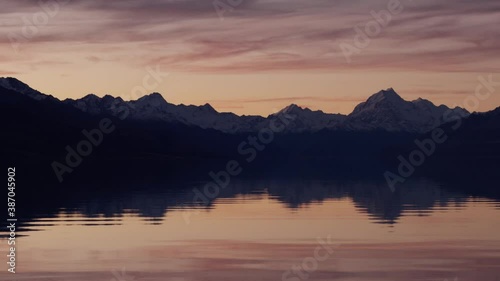 New Zealand autumn season landscape with mountains during sunset in Mt.Cook area with lake reflection. Golden hours with red sky and lake. photo